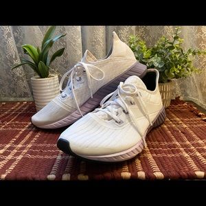 Reebok flash film women’s running shoes white with purple outer sole.